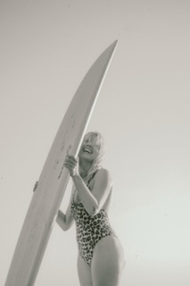 Girl smiling on surfboard