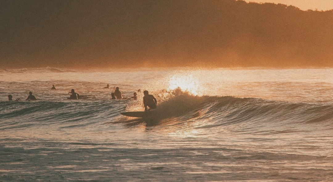 surfing at sunset