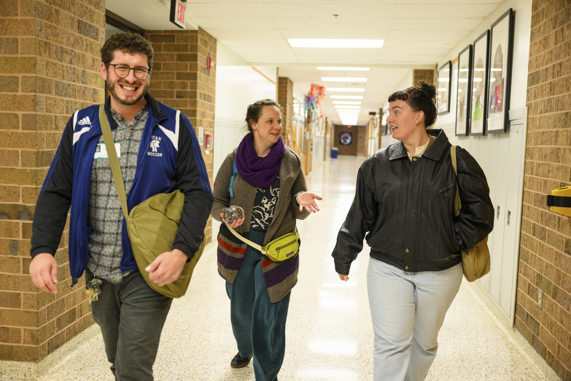 A LIGHT team member walking through the halls of Shaler Area HIgh School with two of LIGHT's partners.