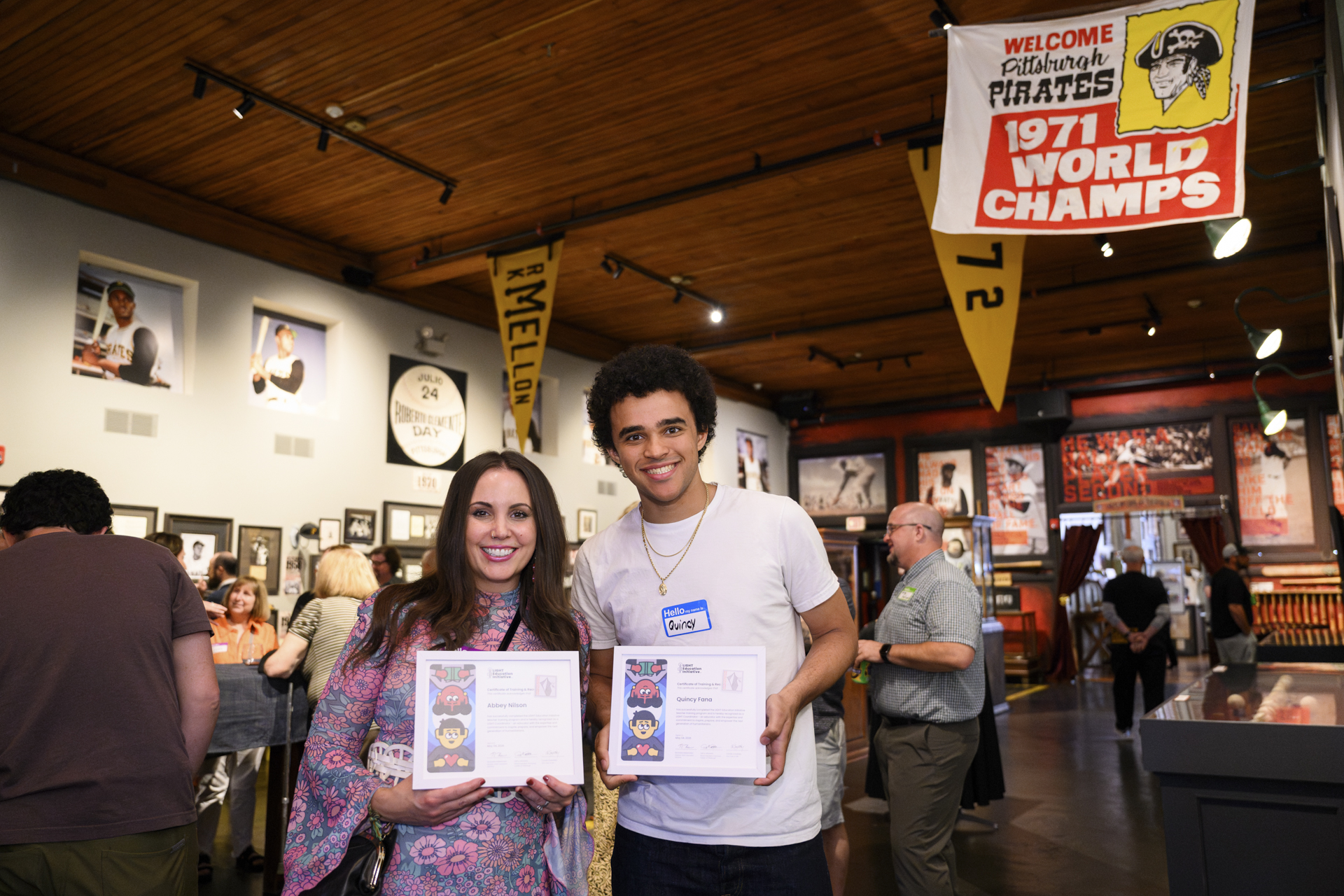 Two certified LIGHT coordinators smile for a photo with their certificates.