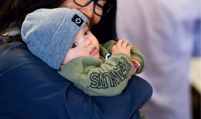 A woman holding a baby