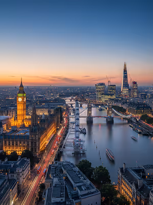 Evening view of London with illuminated Big Ben and Tower Bridge over the River Thames.