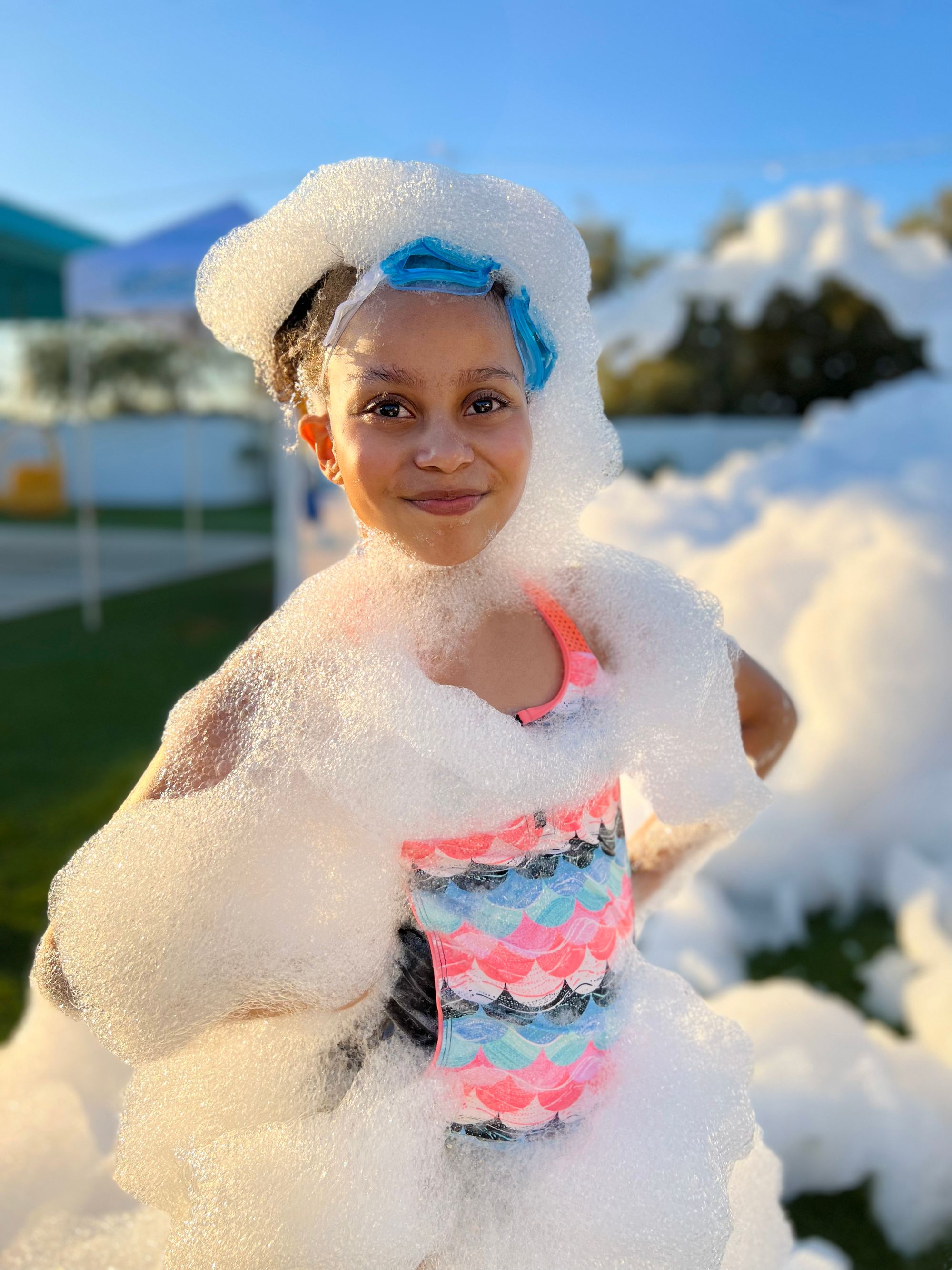 A child covered head to toe in party foam