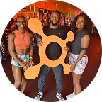 Orangetheory Fitness members holding the OTF icon banner.