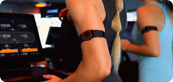 Person running on a treadmill wearing an OTconnect Beat.