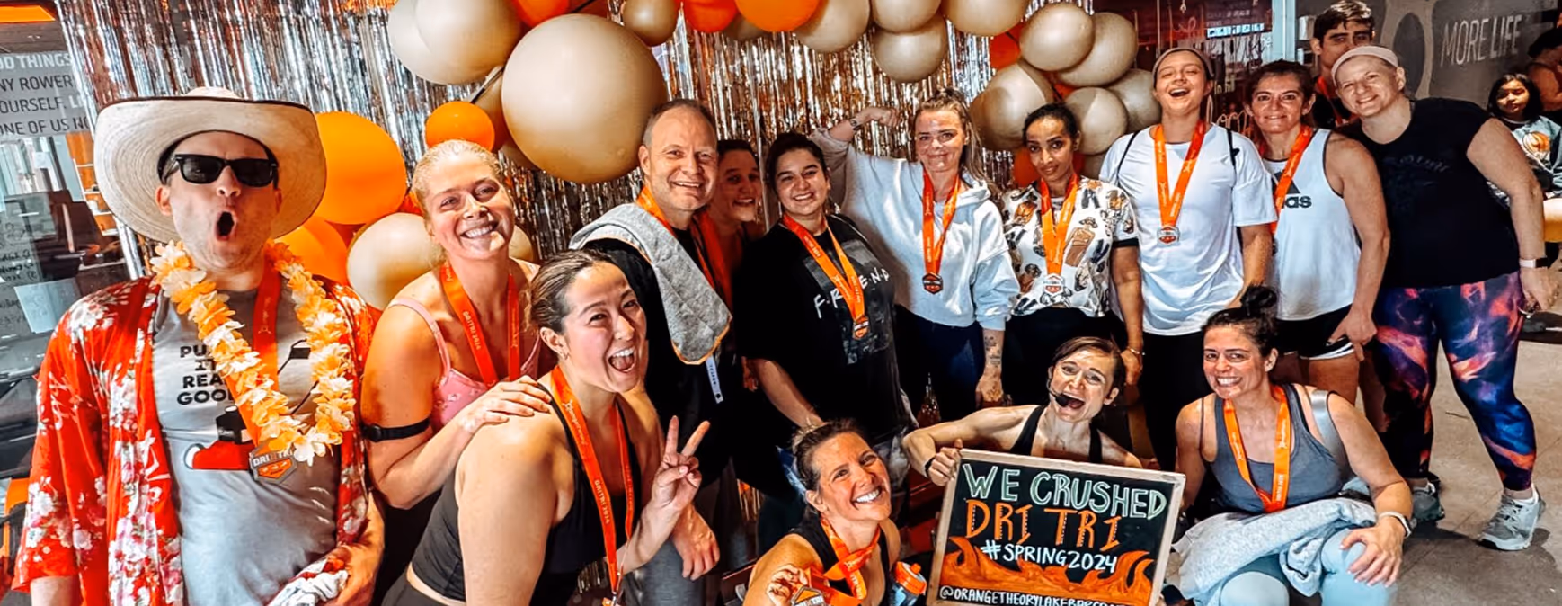 A group of Orangetheory Fitness members smiling after finishing the DriTri session.