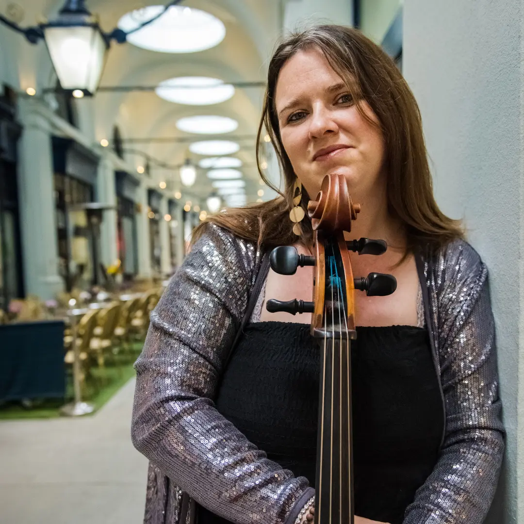 Shirley Smart stands holding a cello