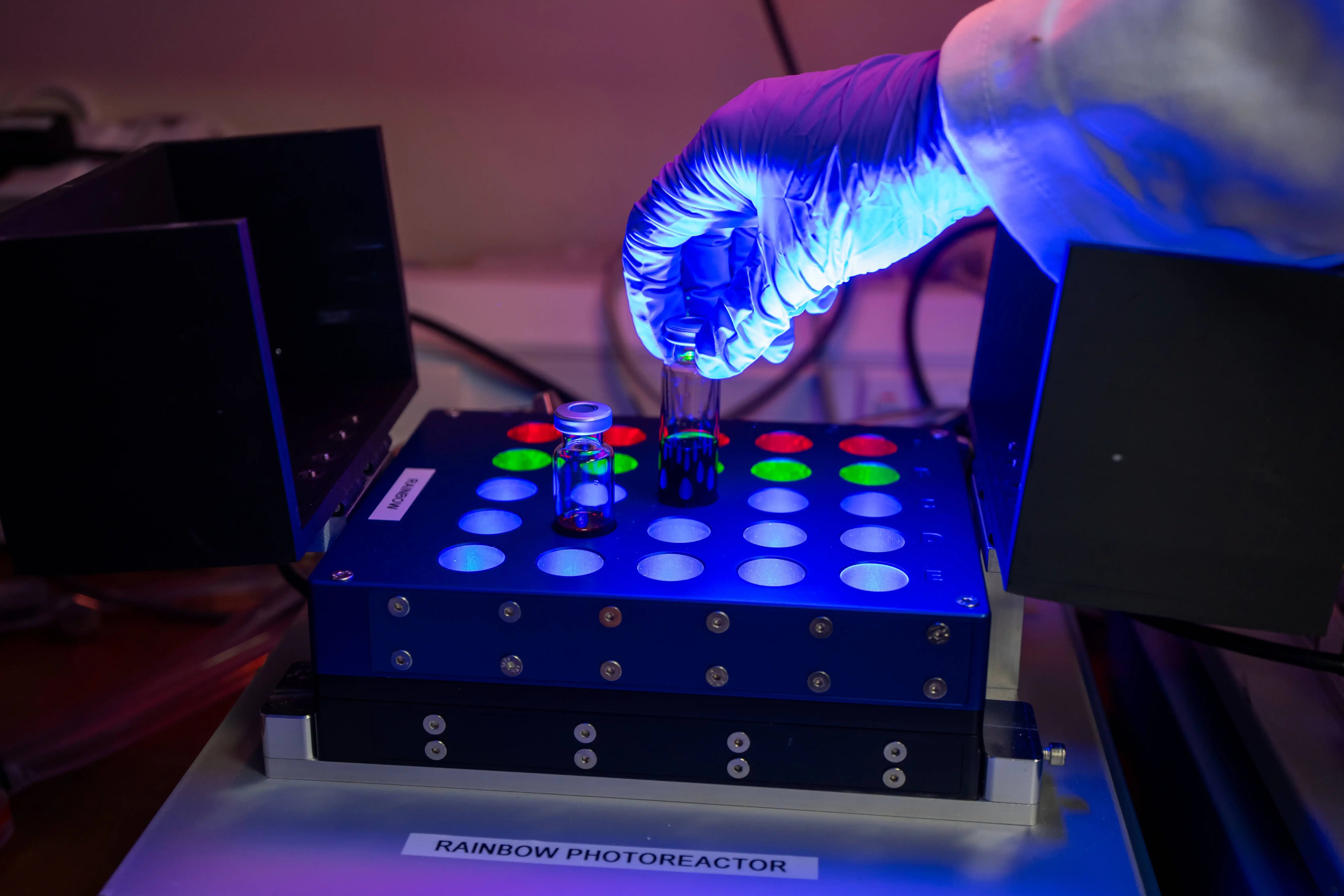 Gloved hand works on an experiment in a laboratory