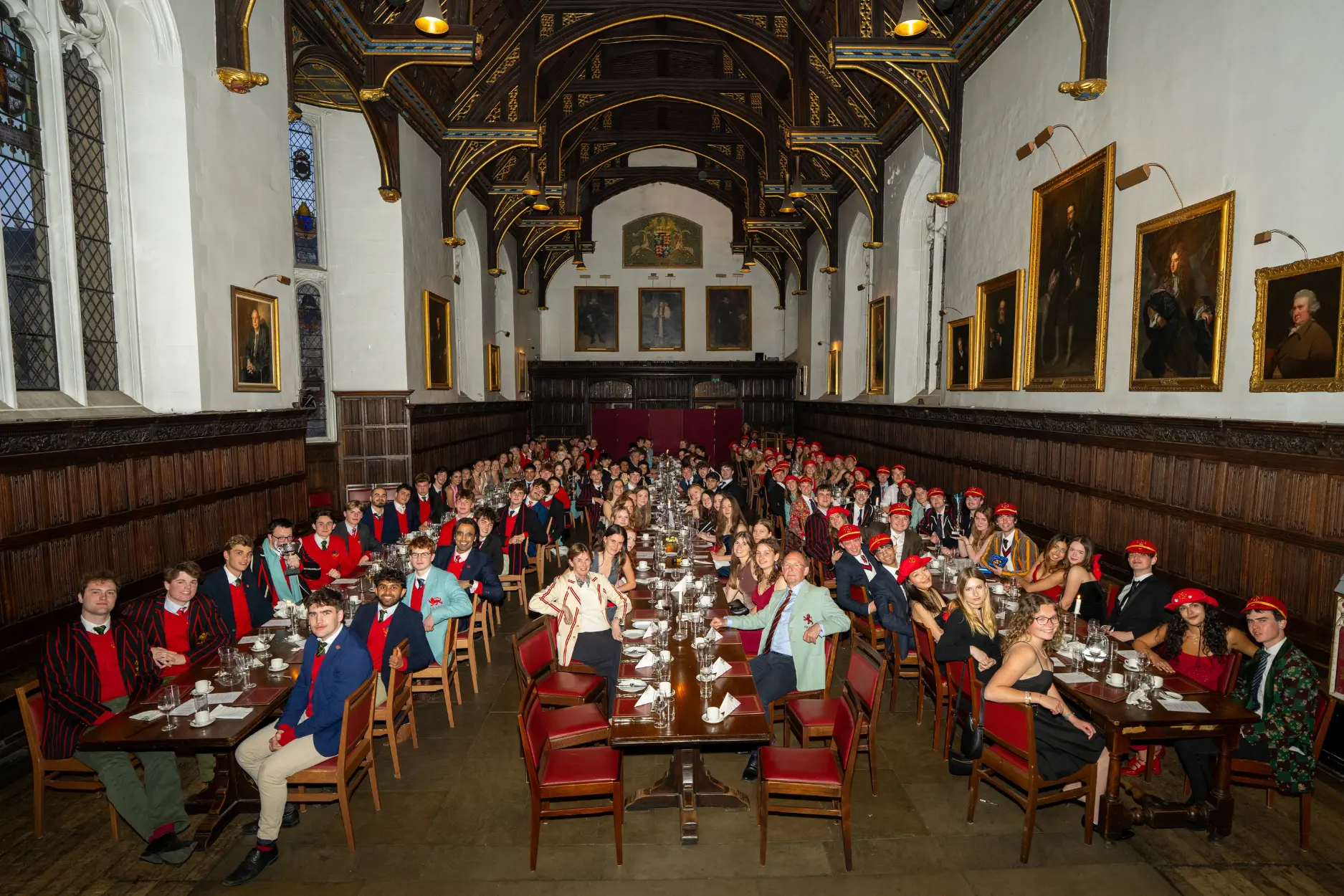 Students sit in the Hall for Colours dinner with the Master and her husband.