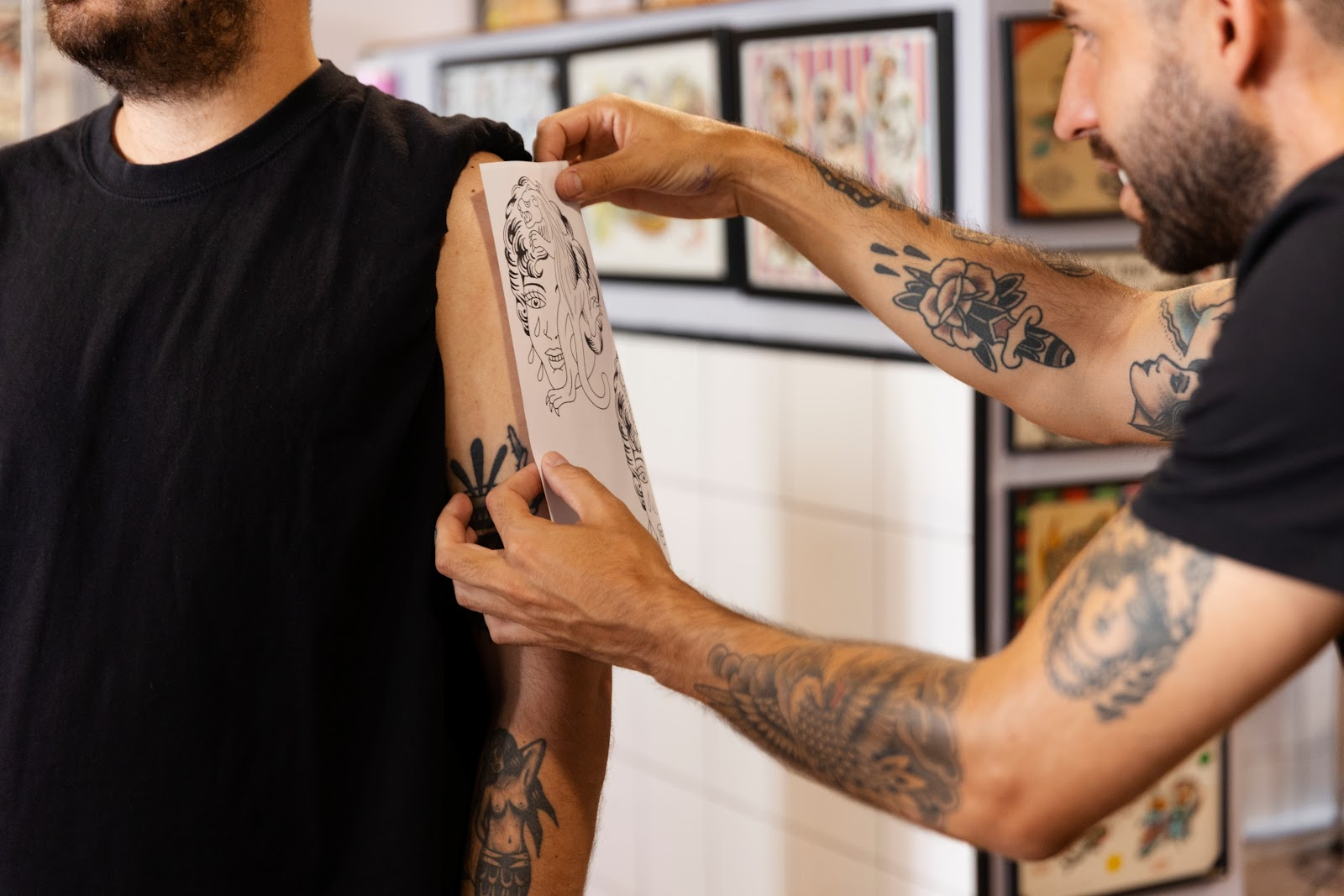 Tattoo artist checking tattoo placement