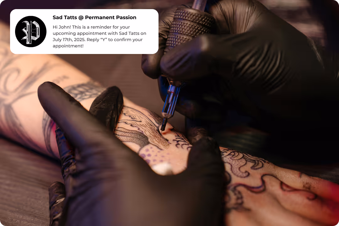 Tattoo artist working with a Porter appointment reminder text visible