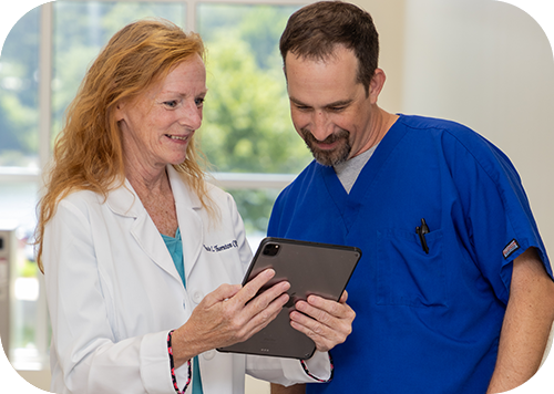 Medical professional review information on a tablet.