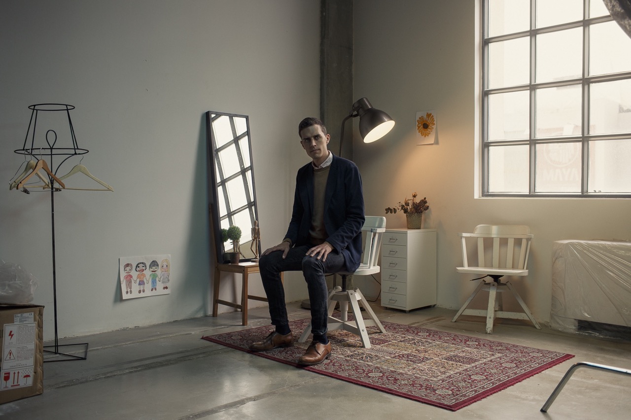Midjourney prompt engineering techniques illustrated in minimalist studio setting with Danish performance artist Christian Falsnaes.