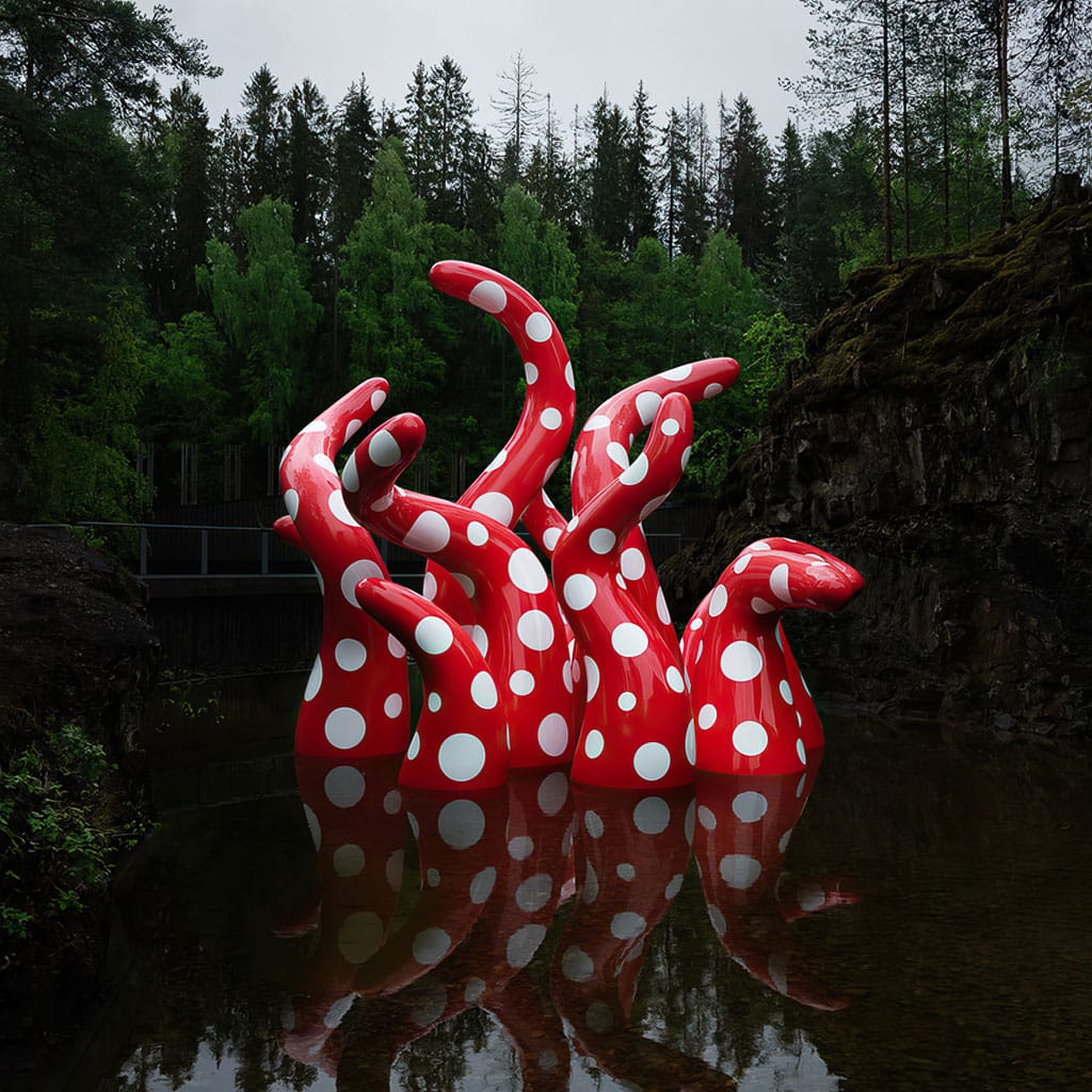 Yayoi Kusama-inspired sculpture with red polka dots in water, showcasing Midjourney prompt engineering techniques.