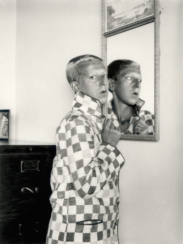 Self-portrait by Claude Cahun, exploring gender identity through Midjourney prompt techniques, vintage monochrome style, and surrealism.
