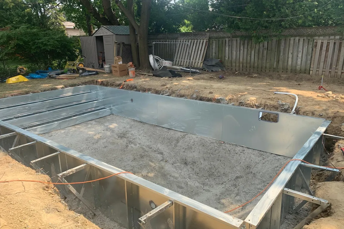 Steel wall pool shell with three-step entry bracing during construction on Wellesworth Drive in Etobicoke