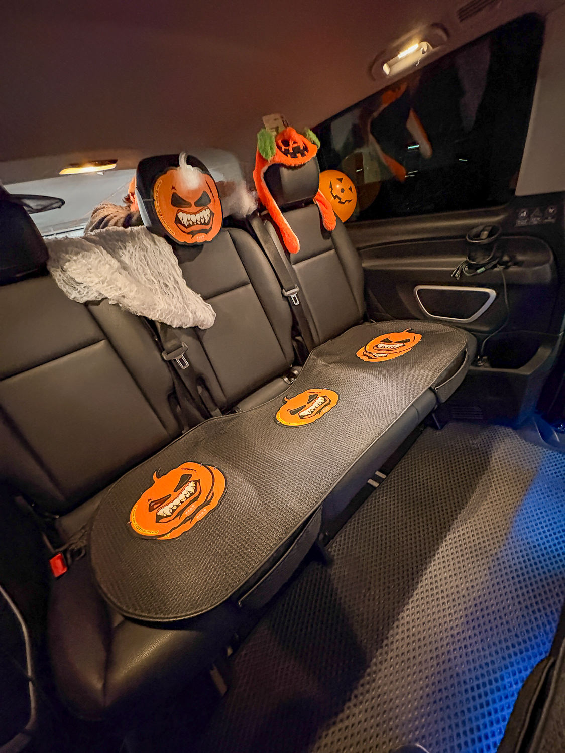 Back seat of the taxi with pumpkin decoration and bat figures
