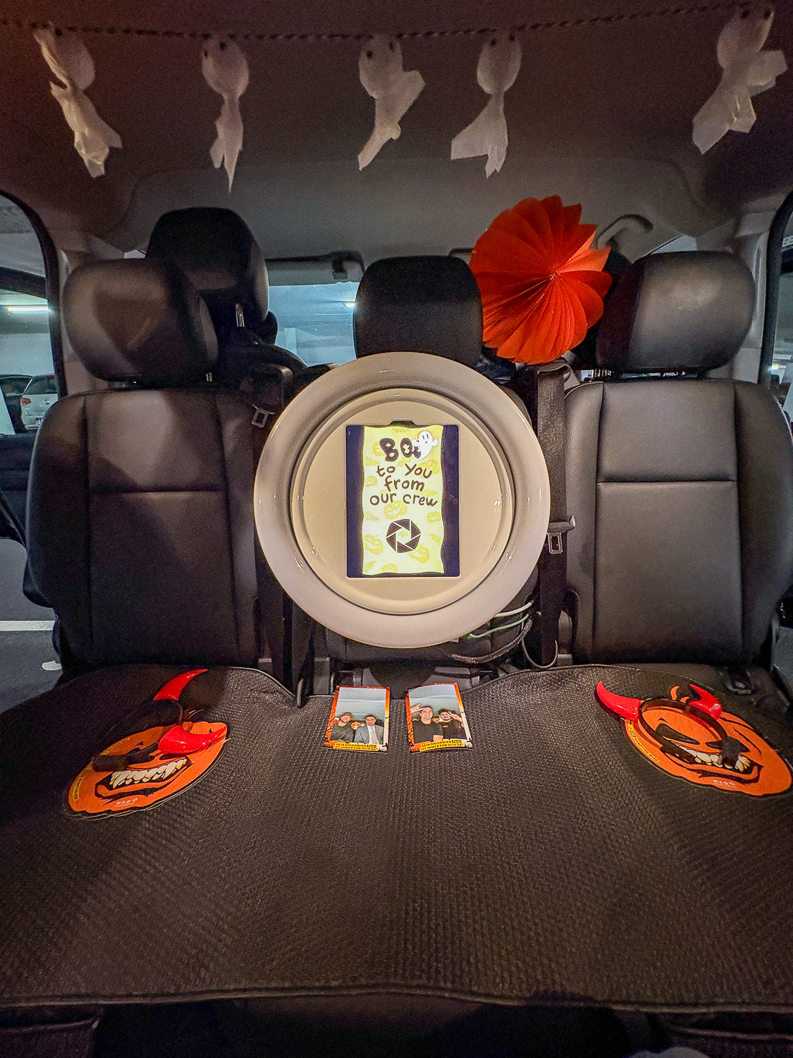 Camera with ring light in the taxi and photo prints on the seat bench