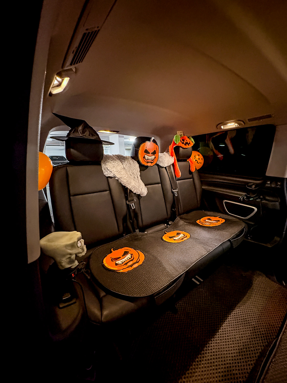 Back seat of the Halloween taxi with pumpkins and ghost decorations