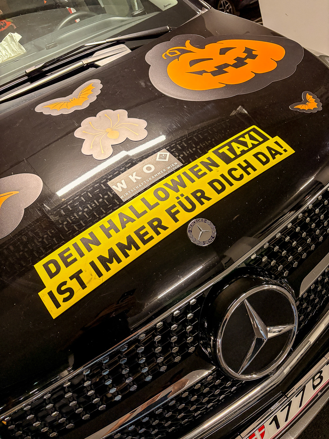 Front of the taxi with a sticker saying your Halloween taxi is always there for you