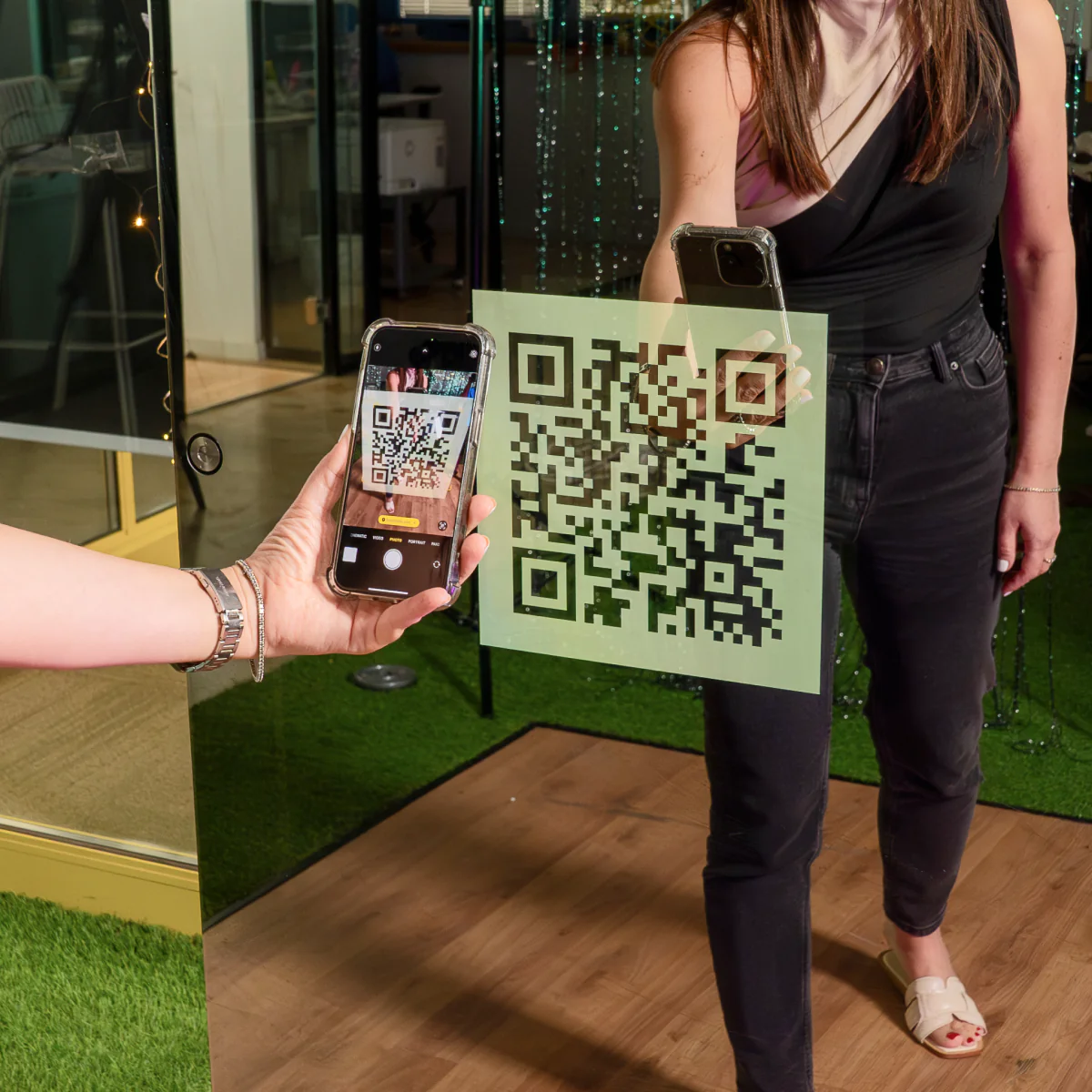 Guest scanning the QR code on the display with her smartphone