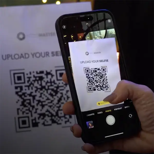 Guest scanning the QR code with a smartphone to upload a selfie