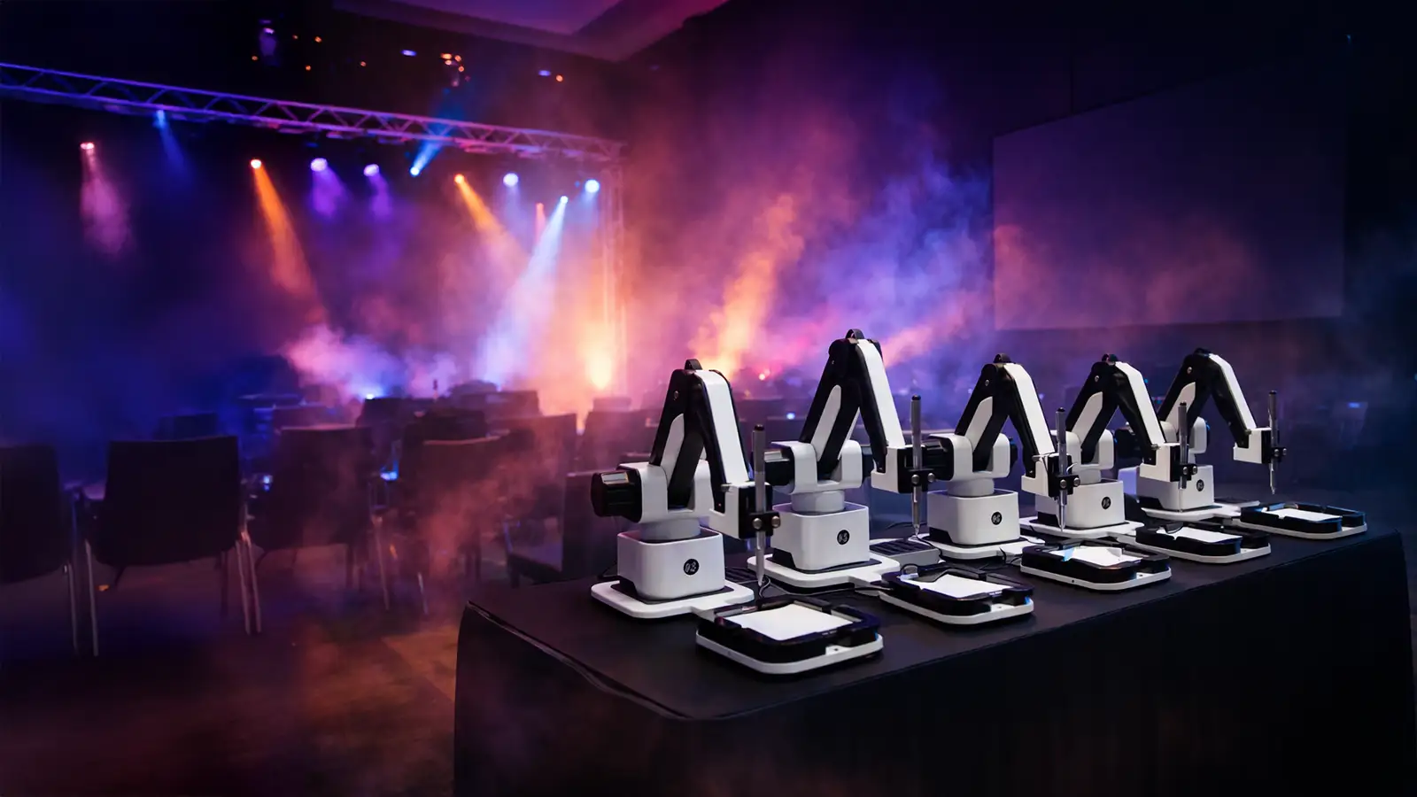 Several AI Sketcher robots side by side on an event stage