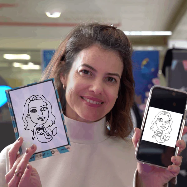 Guest holding her drawn caricature and the digital version on her phone