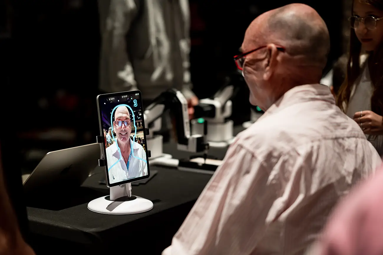 Guest seeing his drawn portrait on the tablet