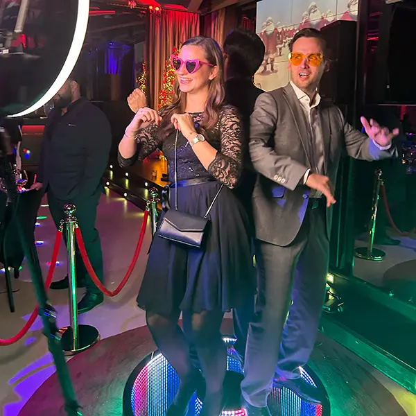 Two guests posing on the 360 degree ground spinner platform