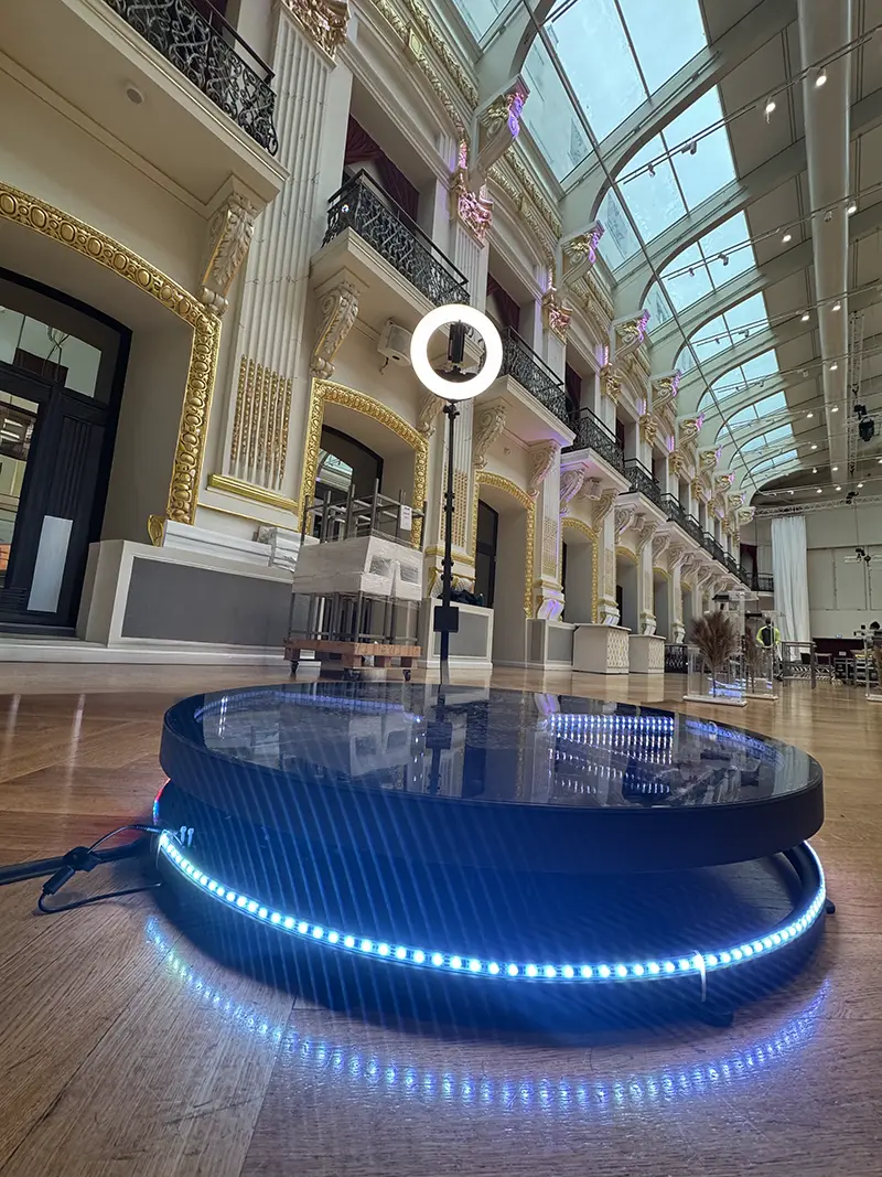 Blue glowing ground spinner platform in a glass-roofed hall