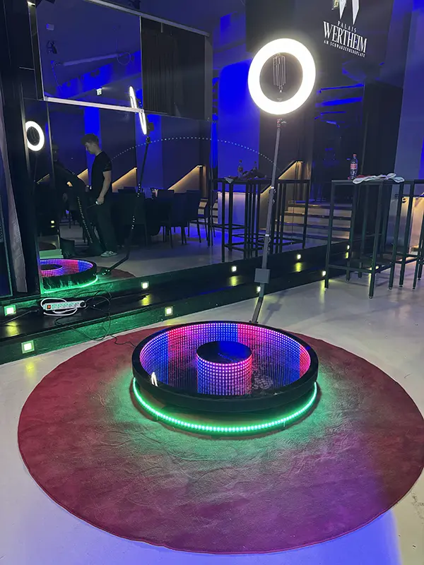 360 degree ground spinner with ring light in a purple lit bar