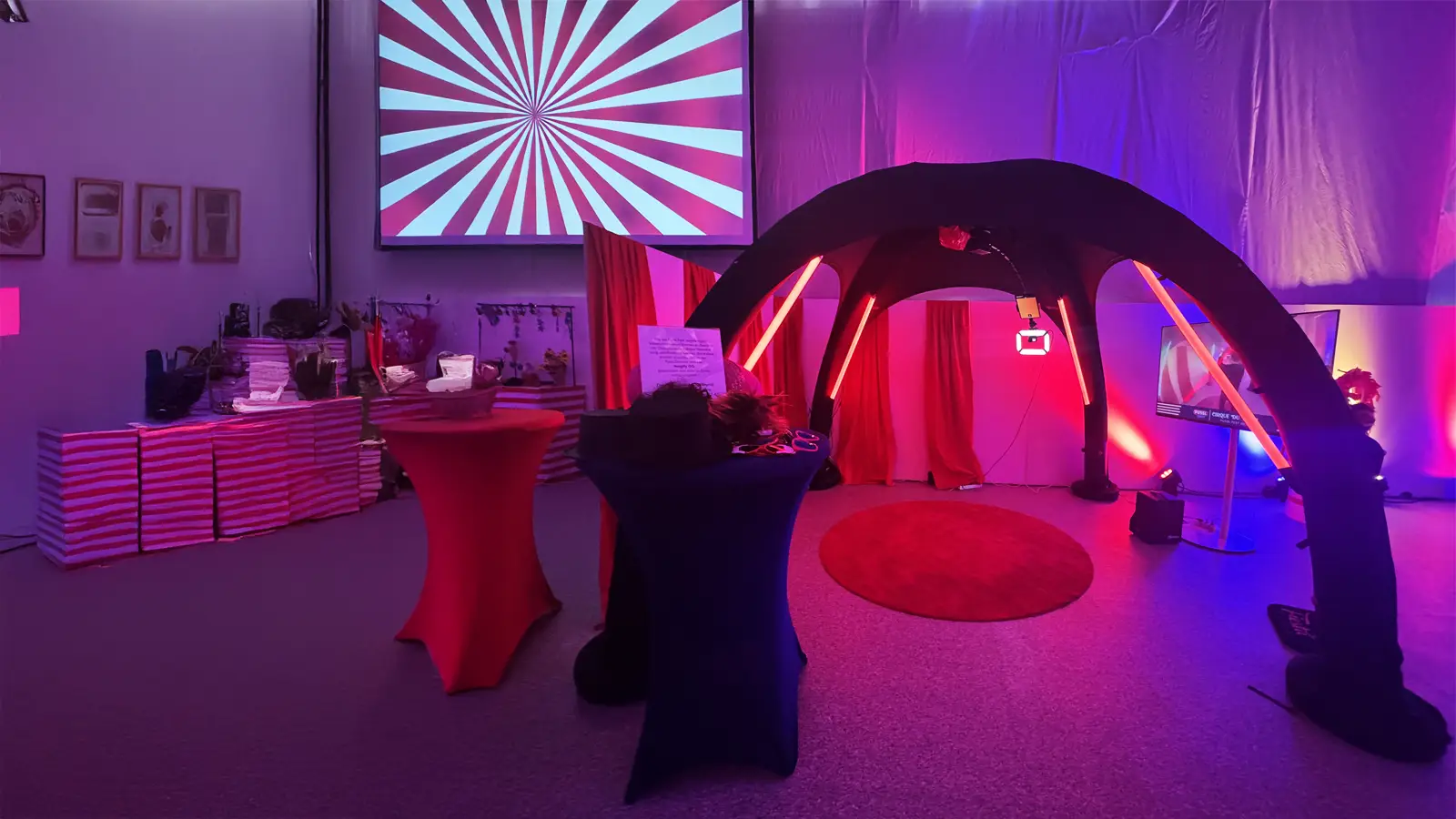360 degree video booth in a pink and purple lit event room