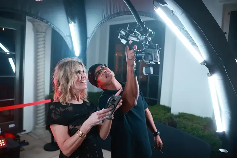 Guests standing under the camera arm of the 360 degree video booth