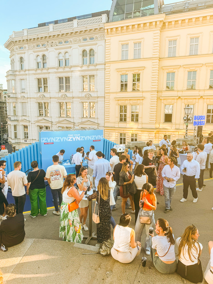 Crowd of visitors in front of the open air stand at Albertinaplatz