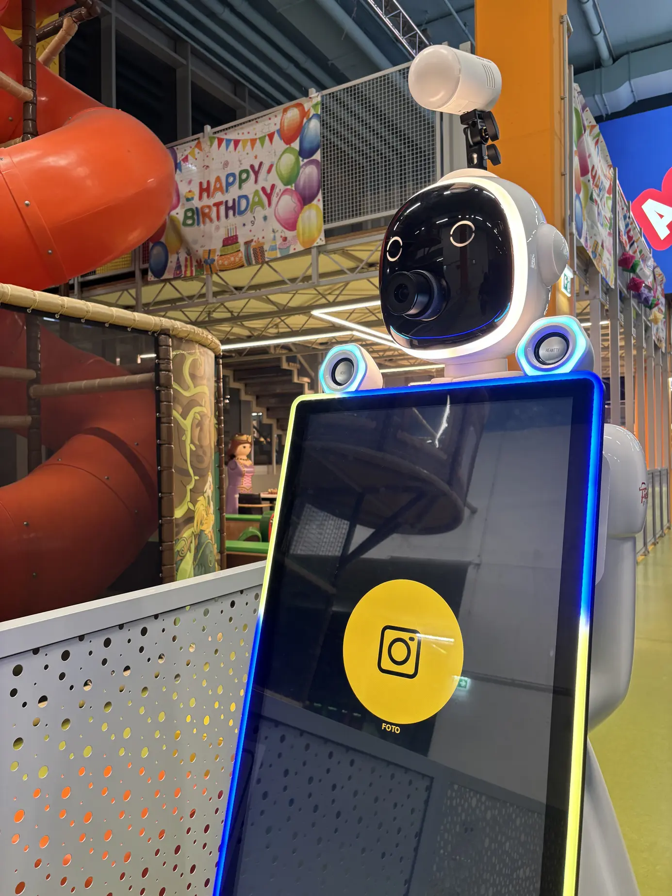 Der Roboter vor dem Spielbereich neben einem Happy-Birthday-Banner