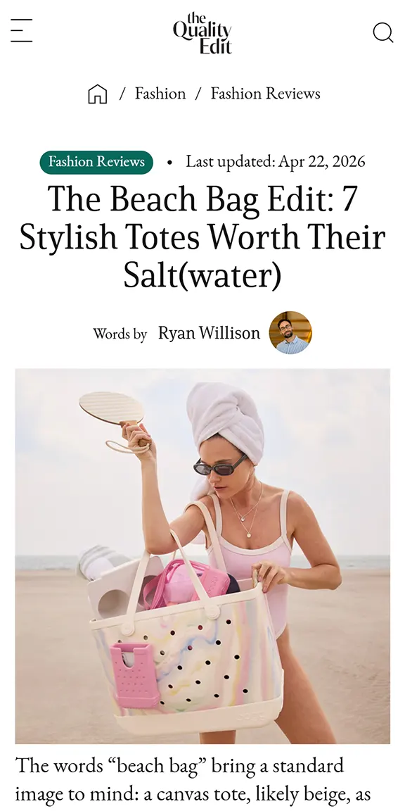 Woman in swimsuit and towel turban holding a multicolor perforated tote bag on the beach.
