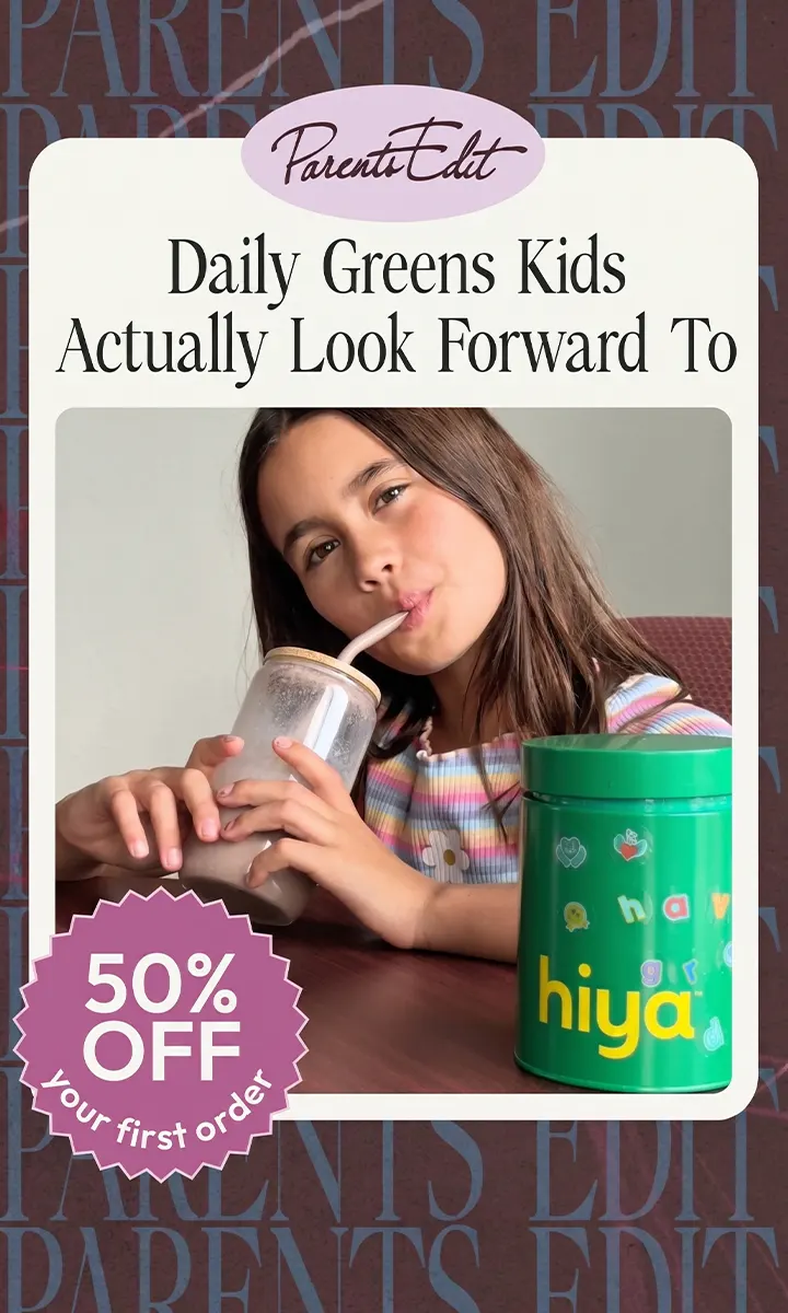 Girl drinking a smoothie through a straw with a green Hiya container on a table.