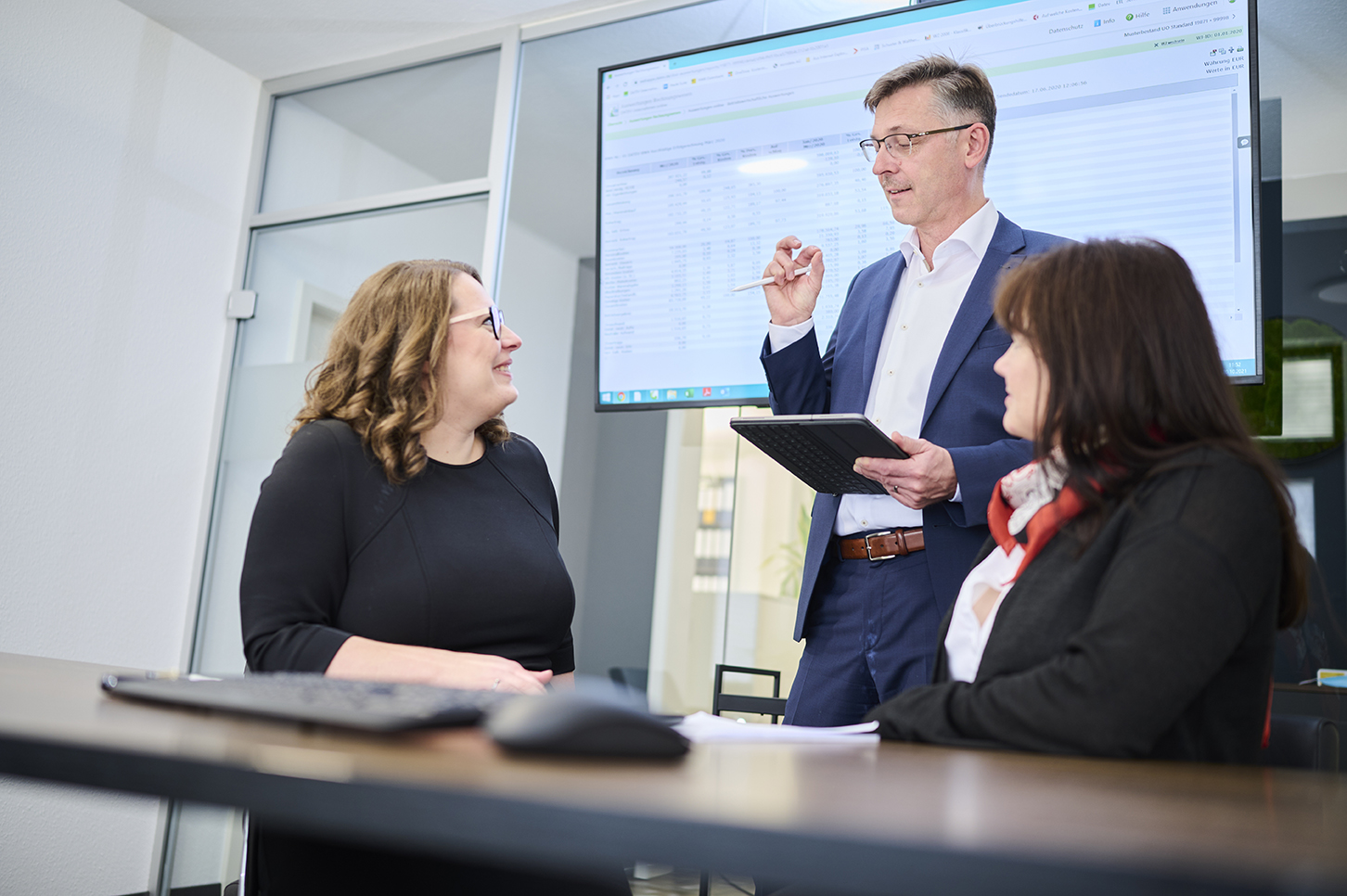A wooden walkway leading to a building with a wooden deck.