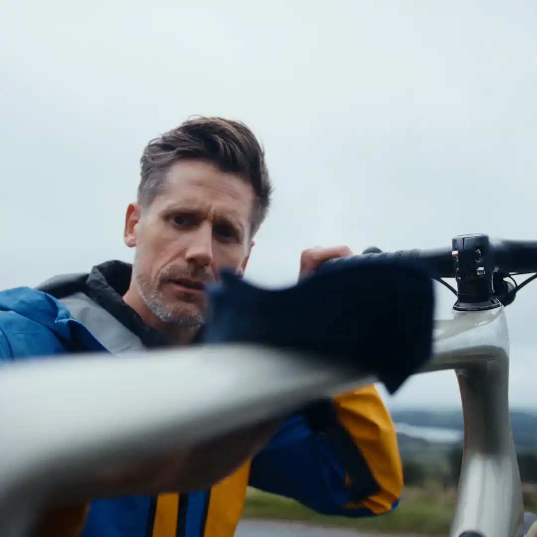 Man cleaning bike from Branded Content film
