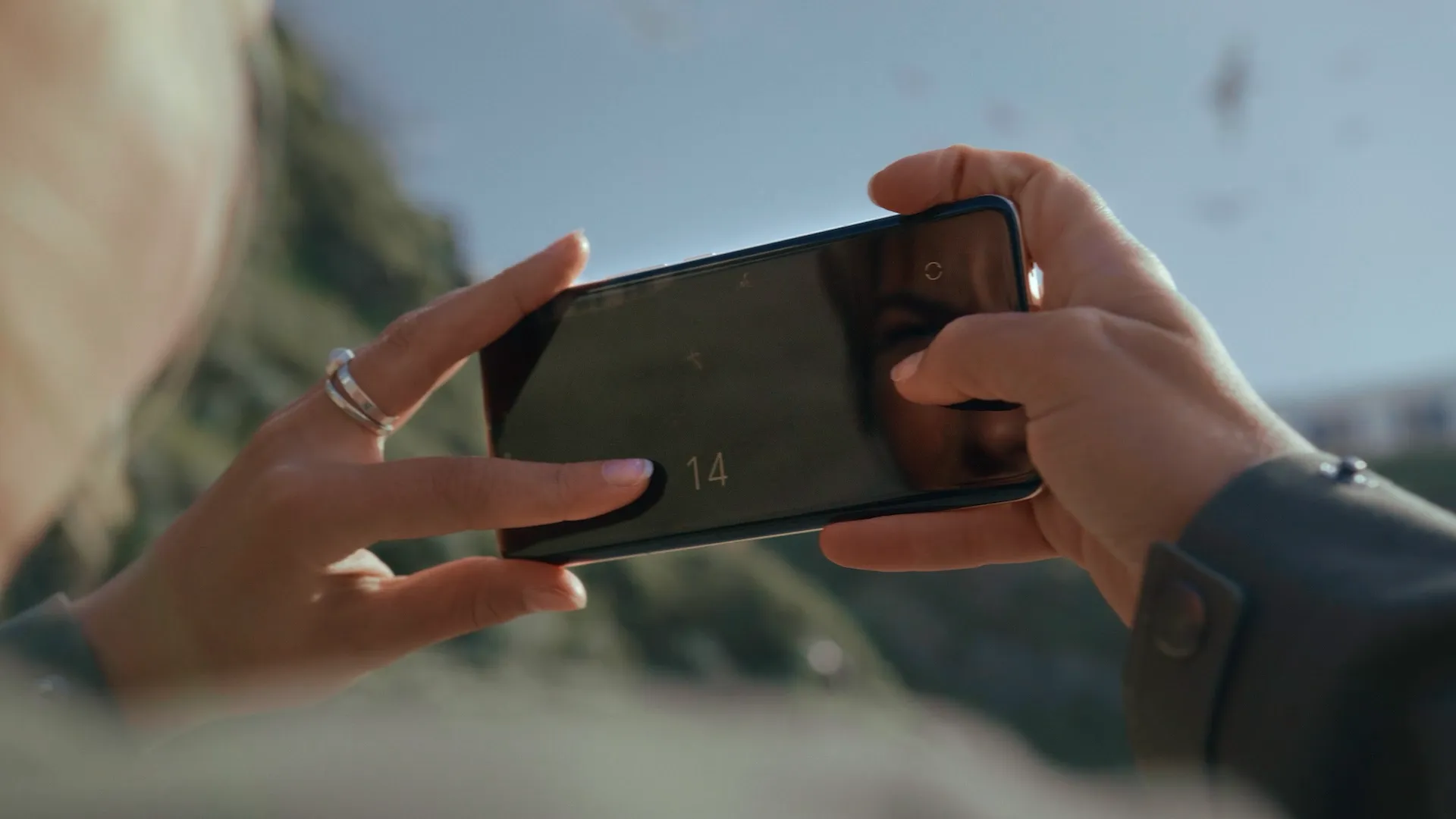 Woman using a phone on a beach