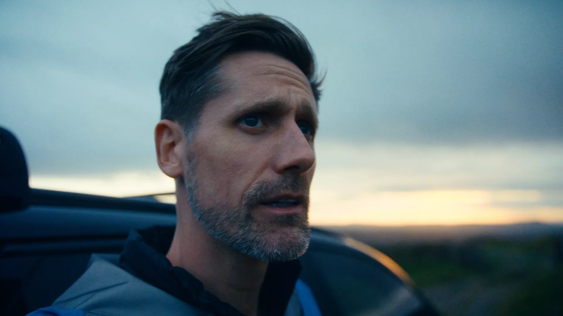 A cyclist looks at the sky for bad weather