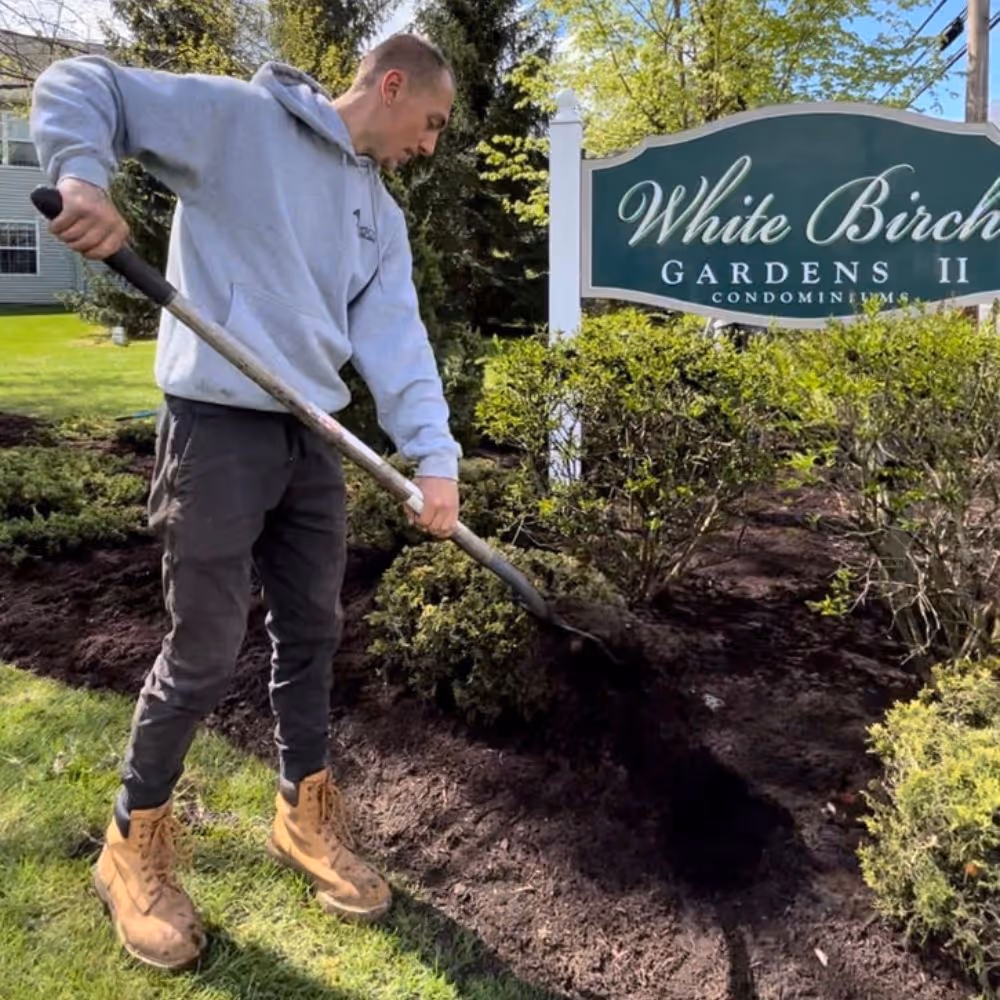 Man shoveling mulch