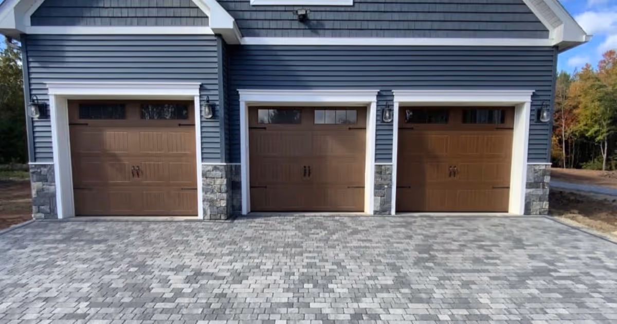 Garage with pavers on driveway