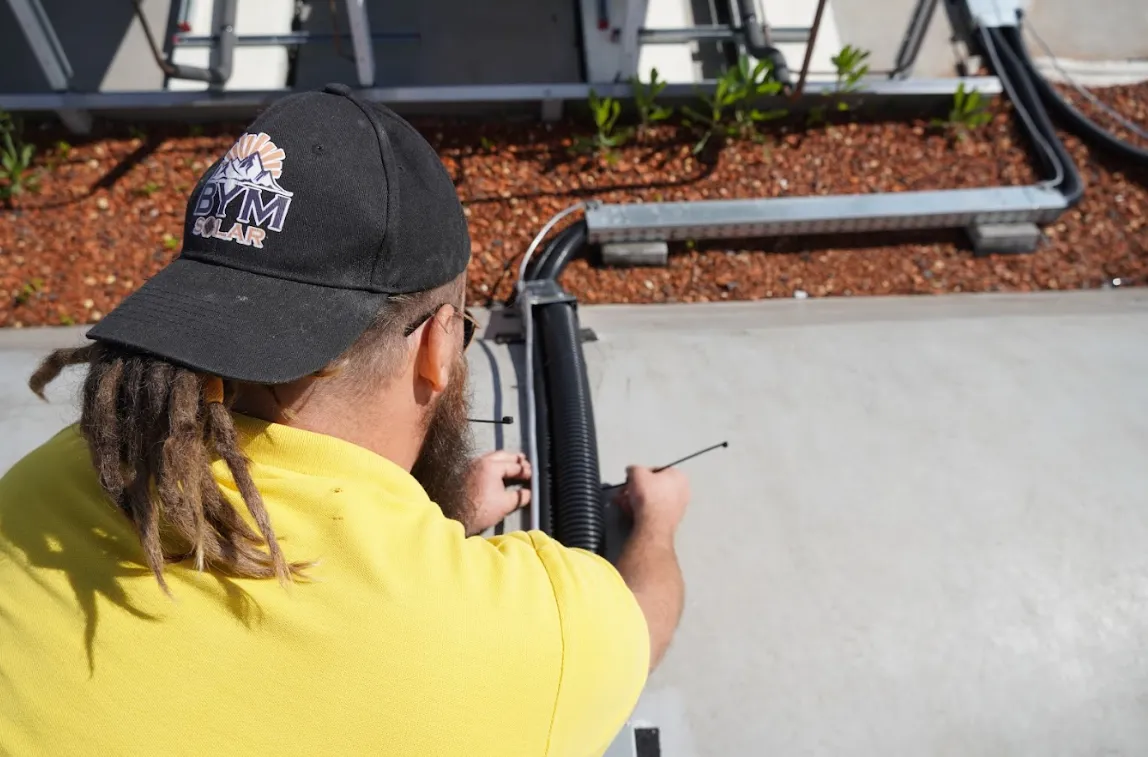 solar installer attaching cables