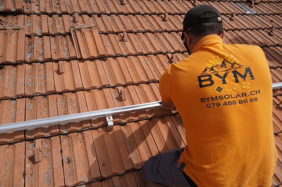 solar installer screwing solar base