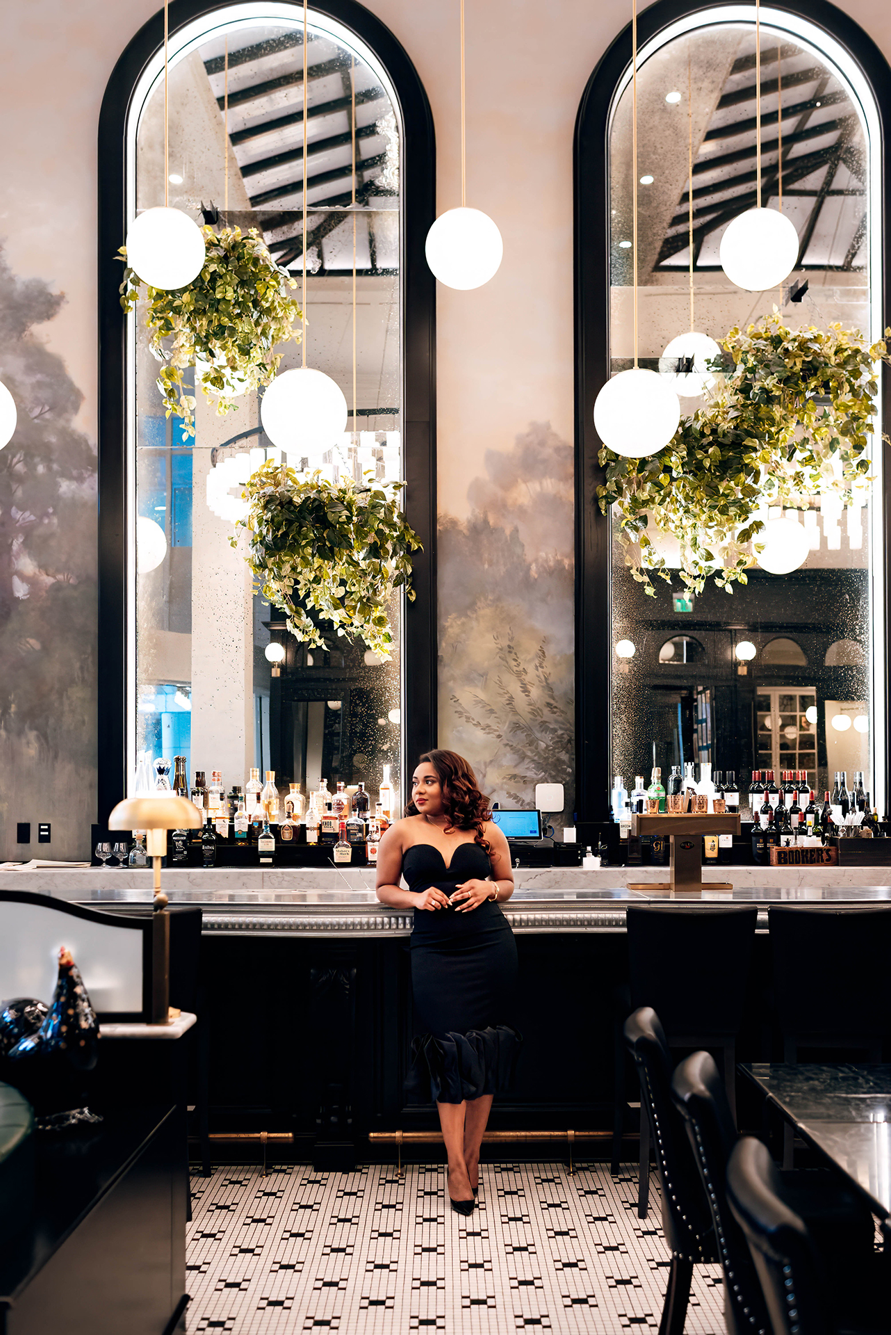 Jacinda Merchant owner of J'Adore Bridal, branding portraits at La Belle Helene in Charlotte, NC. Leaning against the bar. 