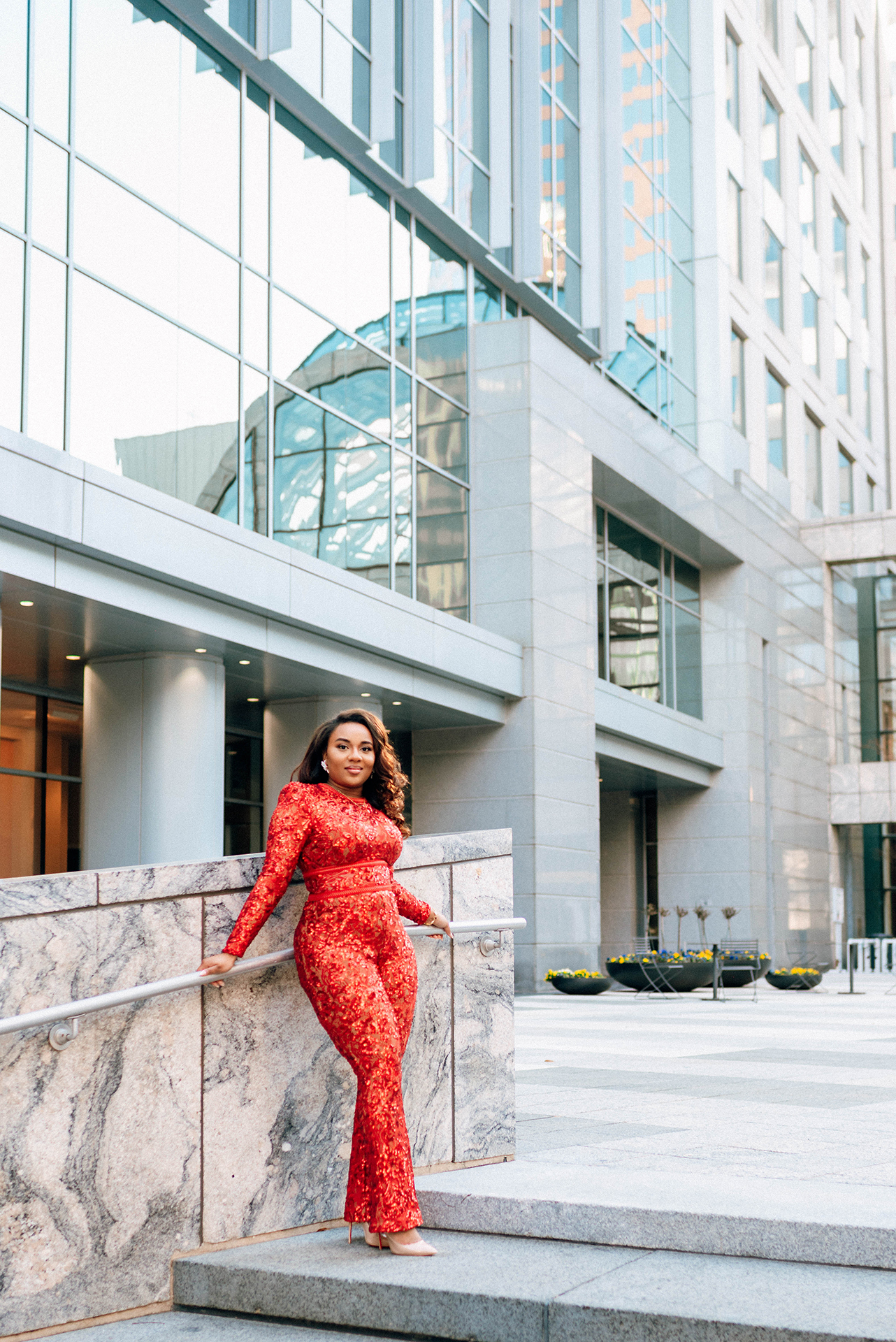 Jacinda Merchant owner of J'Adore Bridal, branding portraits at La Belle Helene in Charlotte, NC. Leaned against railing  outside of restaurant