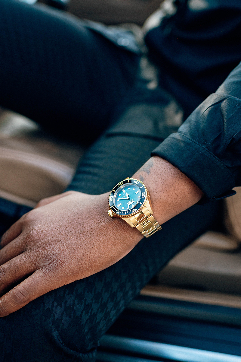 Elopement styled shoot in Camp North End Charlotte, NC with same-sex couple in classic BMW convertible. Partner in driver's seat close up of watch.