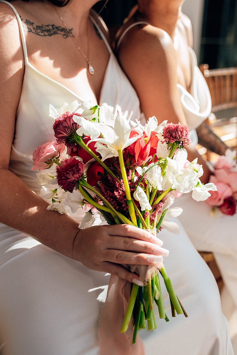 Wedding styled shoot at 220 North Tryon in Charlotte, NC and Foundation of the Carolinas art gallery. Couple sitting together close up of bouquet